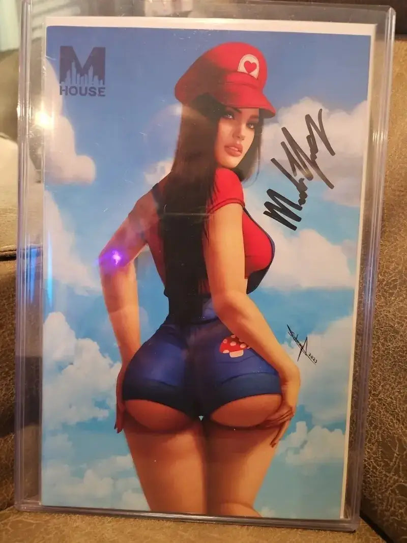 Woman in red hat with Limited Edition Super Mario Comic Autographed by Melinda Young.