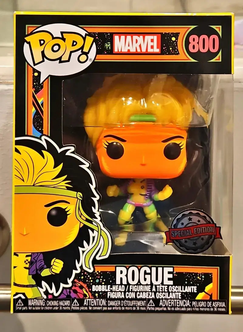 Close-up of Glow-in-the-Dark Rogue Funko Pop! in a box with background image and box shadow.